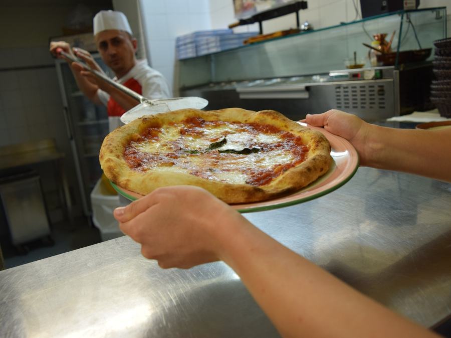 Pizza appena stesa pronta per la cottura durante il corso di pizza al Rubaconte